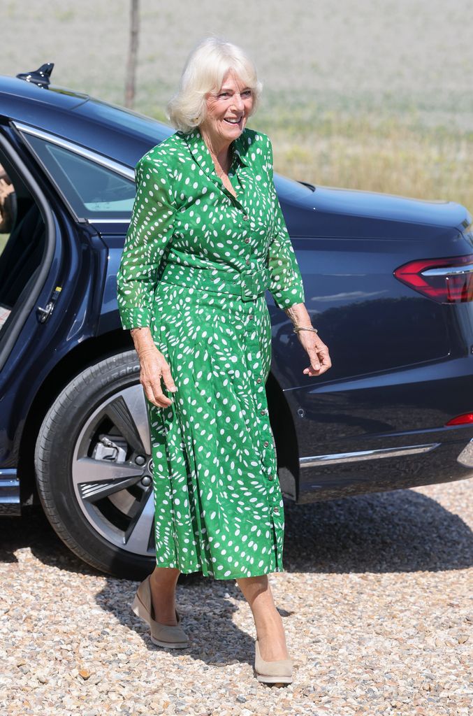 Queen Camilla in green dress walking on gravel