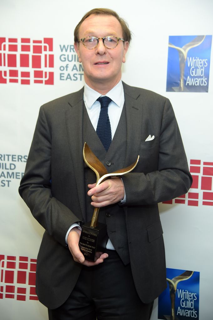 Hugo Guinness holding an award
