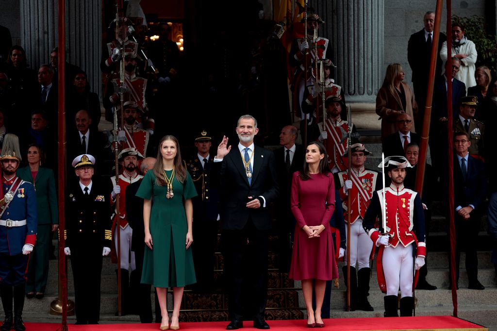 king, queen and princess in front of assembly