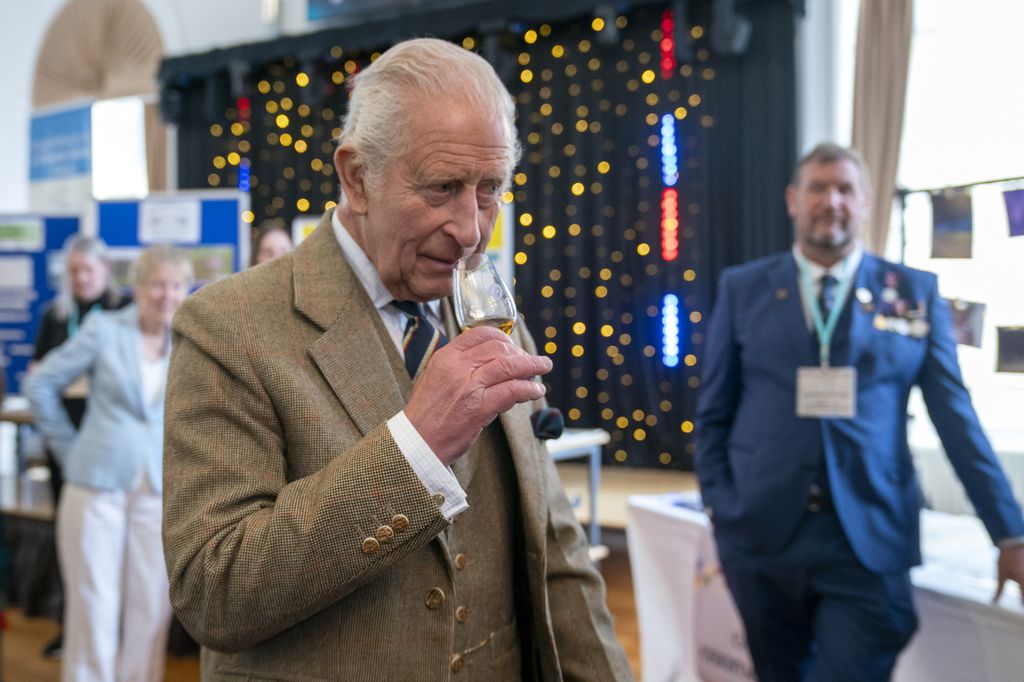King Charles sniffing whisky