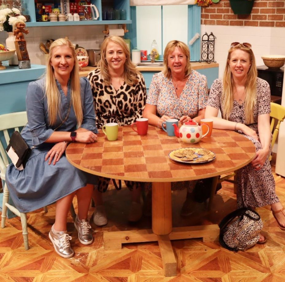 Rebecca Adlington, Chloe Adlington, their mum and Lauren Adlington sat at a round wooden table in a makeshift kitchen