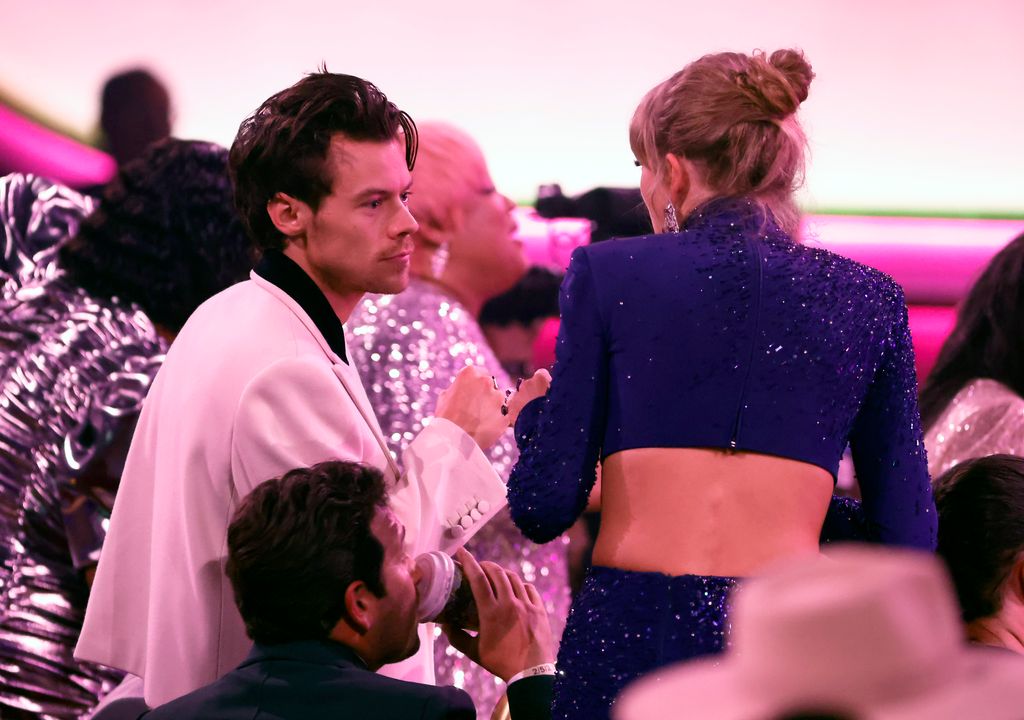 Harry Styles and Taylor Swift fist-bumping at the Grammys