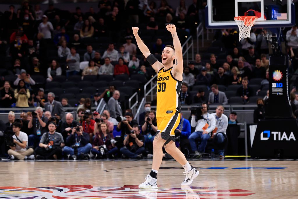 connor mccafery with his arms raised on basketball court