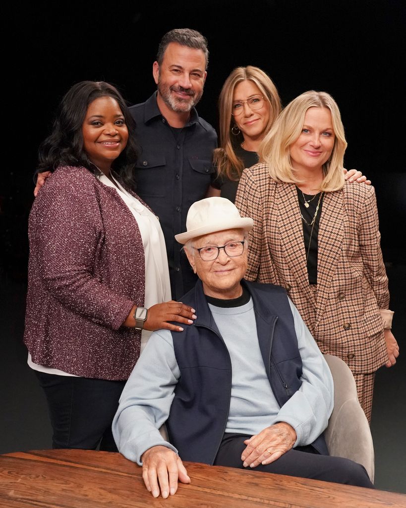 Octavia Spencer, Jimmy Kimmel, Jennifer Aniston and Amy Poehler standing over Norman Lear