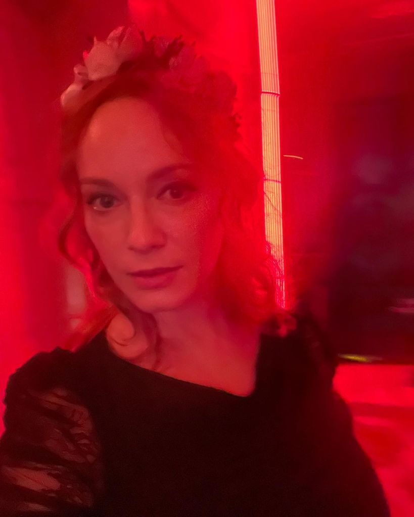christina hendricks wearing black lace in selfie lit by red light