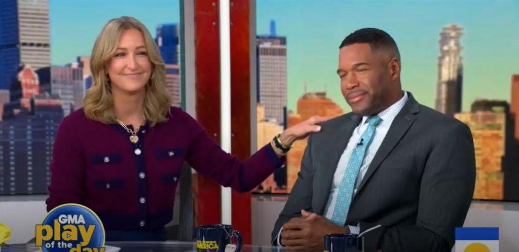photo of lara spencer touching michael strahan shoulder on gma