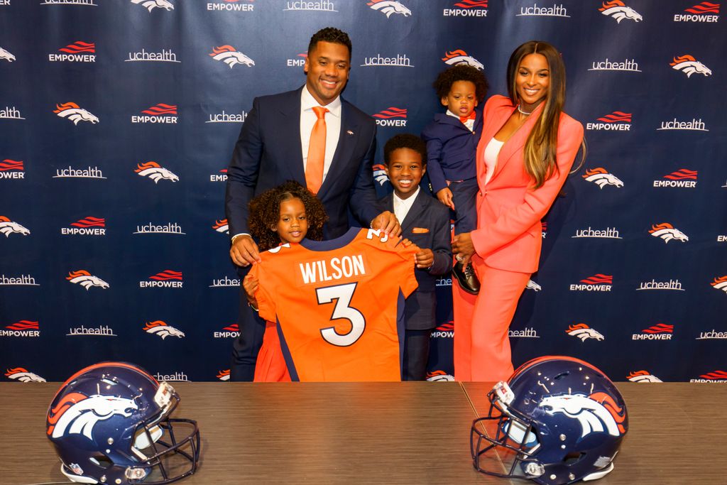 Russell Wilson poses with his family Sienna, Future, Win and Ciara following an introductory press conference on March 16, 2022 in Englewood, Colorado