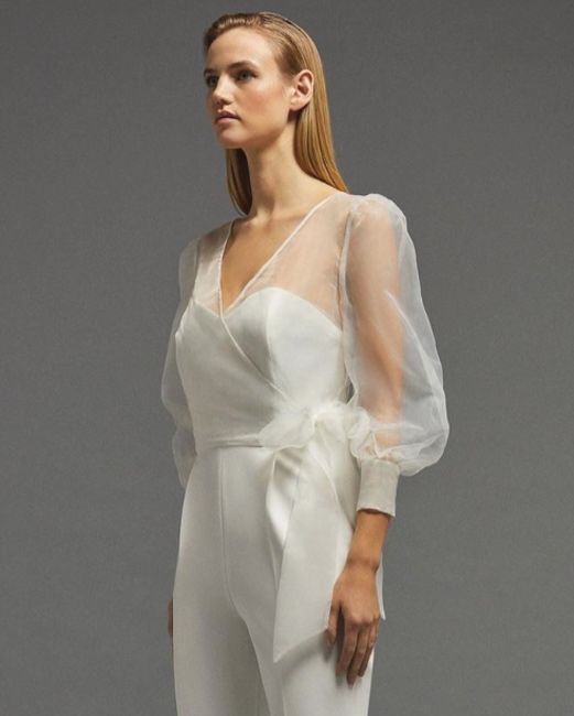 model wears a sheer ivory organza wrap blouse