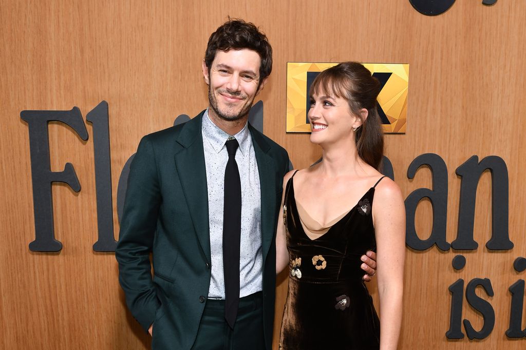 Adam Brody and Leighton Meester smiling at eachother 