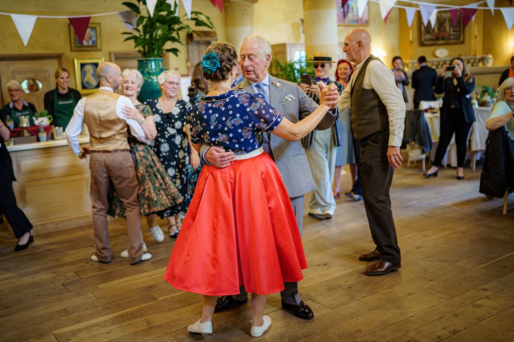 King Charles performing a tango at a dance party