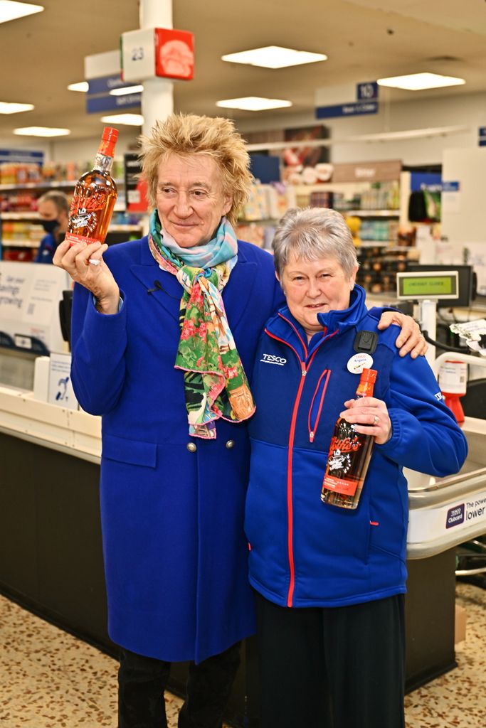 Sir Rod Stewart (L) visits his local Tesco in Bishop's Stortford to celebrate Wolfie's Whisky now being available to buy in more than 400 Tesco stores across the UK on January 30, 2024 in London, England. 