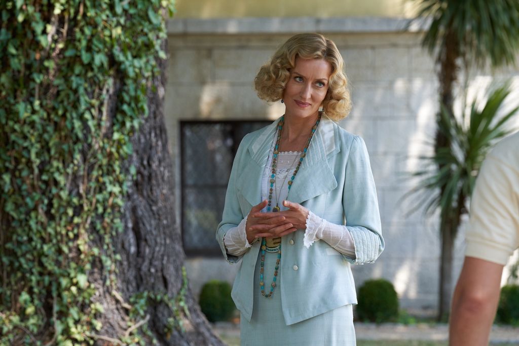 blonde woman in blue suit standing outdoors