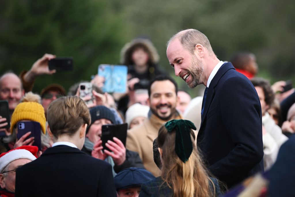 William greeted the crowds with his children