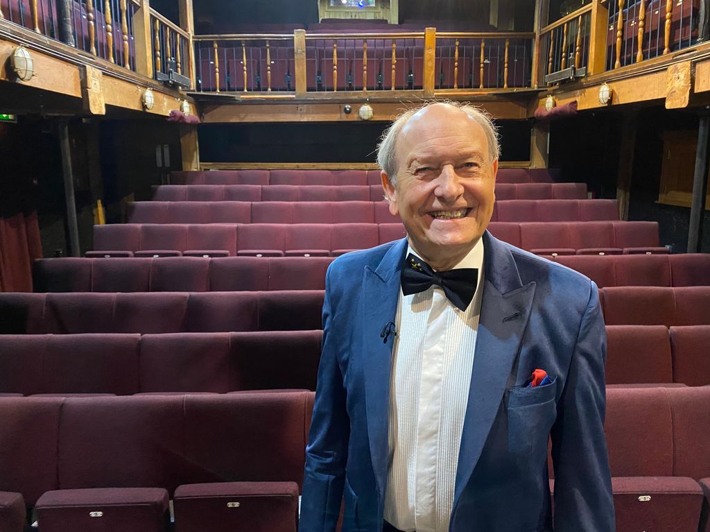 Charlie Ross smiling in a theatre