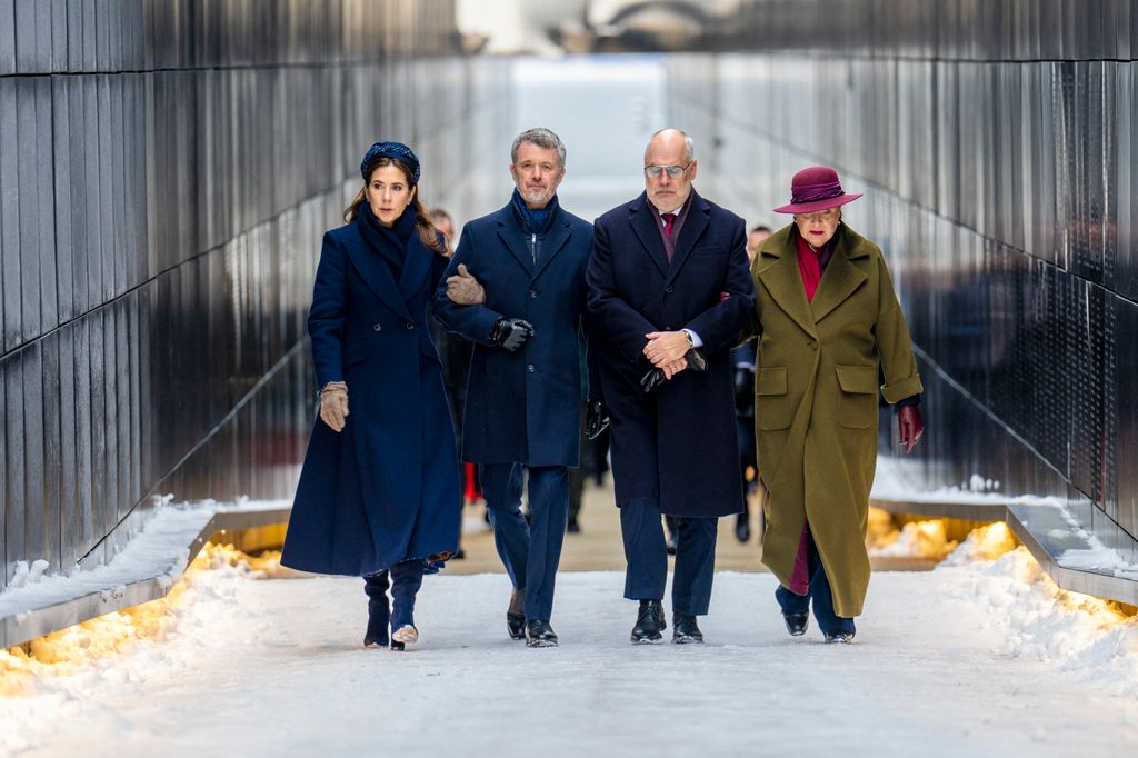 King Frederik X and Queen Mary, Estonia's President, Alar Karis, and First Lady Sirje Karis walking in snow in a line