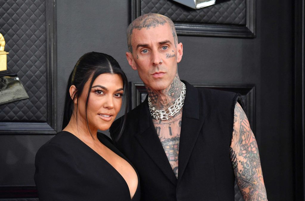 Kourtney Kardashian and Travis Barker on the red carpet at the Grammy Awards 2022
