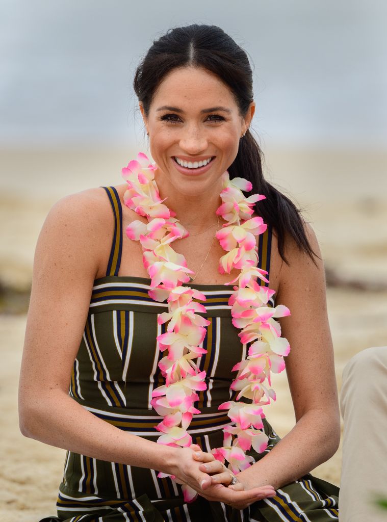 meghan markle on australian beach wearing a lei garland 