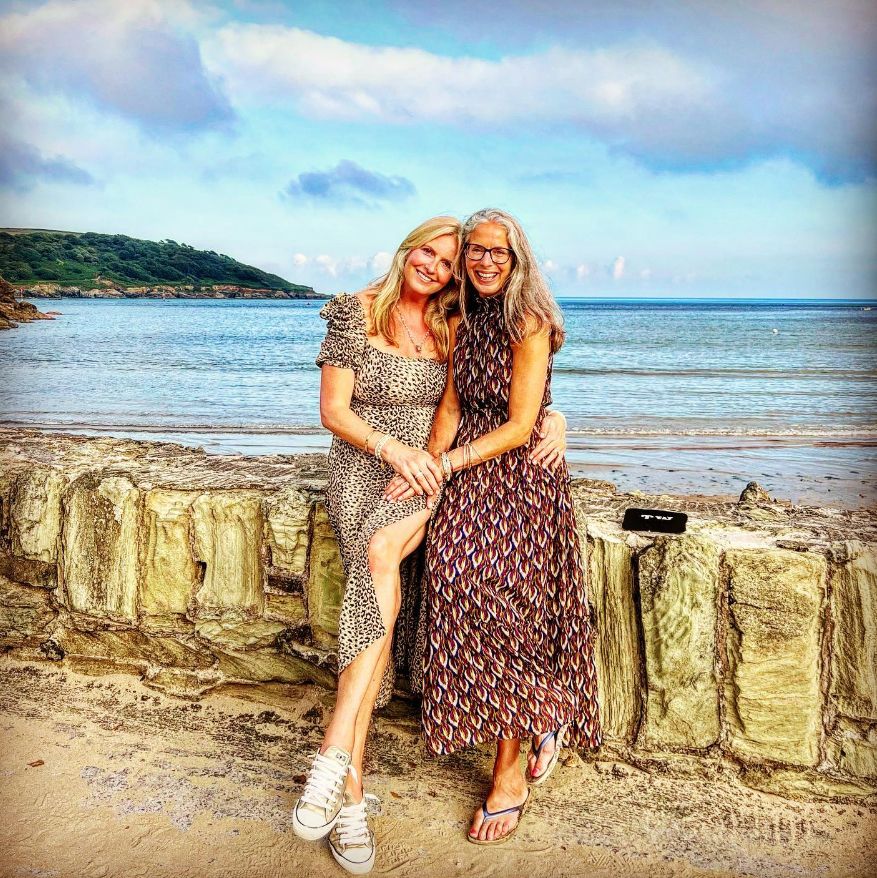 Penny Lancaster embracing a friend on the beach