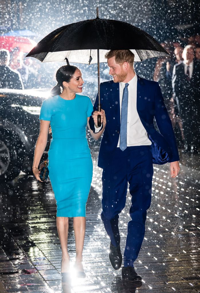 Meghan Markle with her husband Prince Harry in the rain 