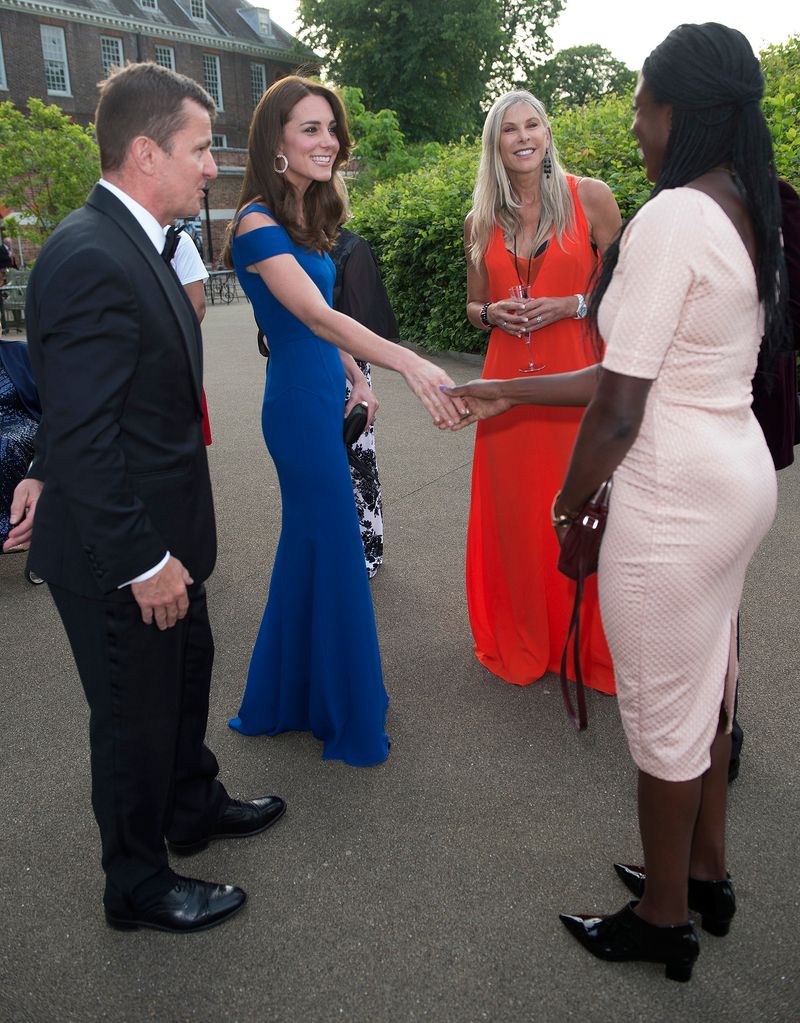 Kate middleton greeting athletes in smart dress