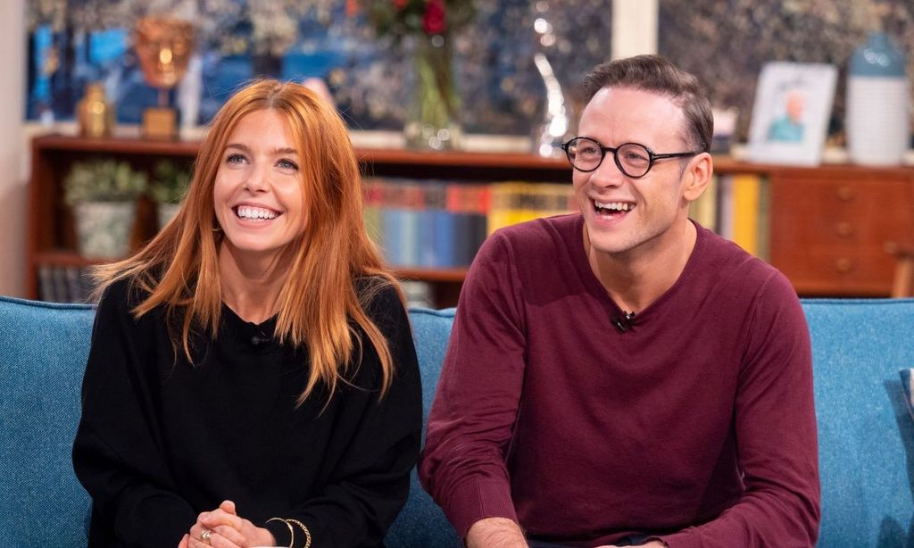 Kevin Clifton and Stacey Dooley laughing on a sofa