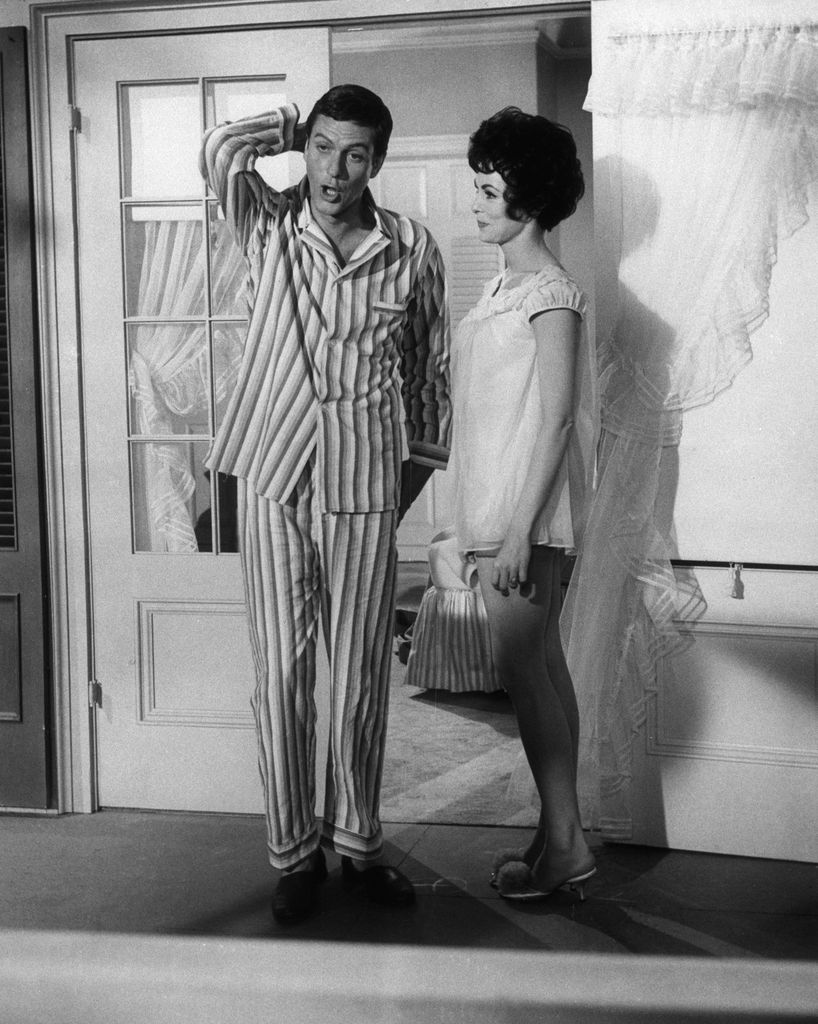 Comedian Dick Van Dyke, scratches his head and mimics an expression, "What do I do now!" While standing by in a shortie pajamas, Janet Leigh, begins to break into laughter. The scene is suppose to be a tender love scene between Jand Dick in the film "Bye Bye Birdie" to be released by Columbia. In evets that follow, the actress finds that making a love scene with a comedian has its problems.