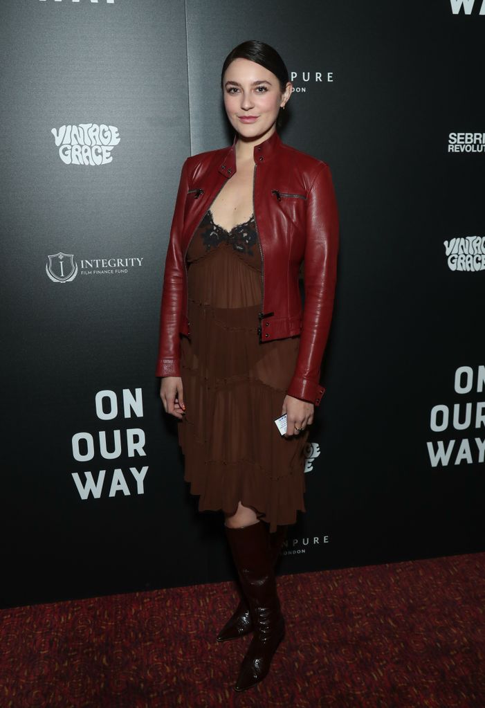 Gracie teamed the sheer dress with a red leather jacket and boots 