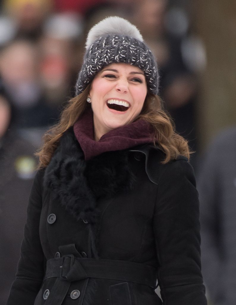 Kate Middleton w czapce z pomponami reaguje po uderzeniu piłki podczas meczu hokejowego Bandy z księciem Williamem, księciem Cambridge, podczas którego dowiedzą się więcej o popularności tego sportu podczas pierwszego dnia ich królewskiej wizyty w Szwecji i Norwegii 30 stycznia 2018 w Sztokholmie, Szwecja.  