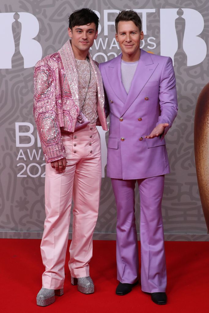 Tom Daley in a sparkly pink suit and Dustin Lance Black in a purple suit