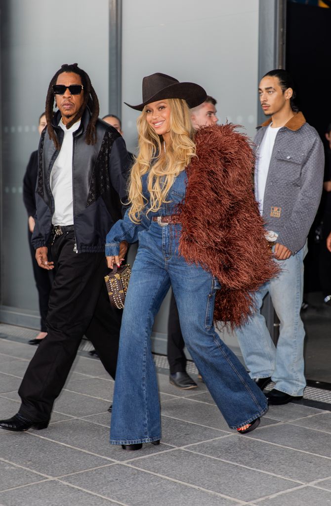Beyonce and Jay-Z are pictured with Julez Smith walking behind them at the Louis Vuitton fashion show