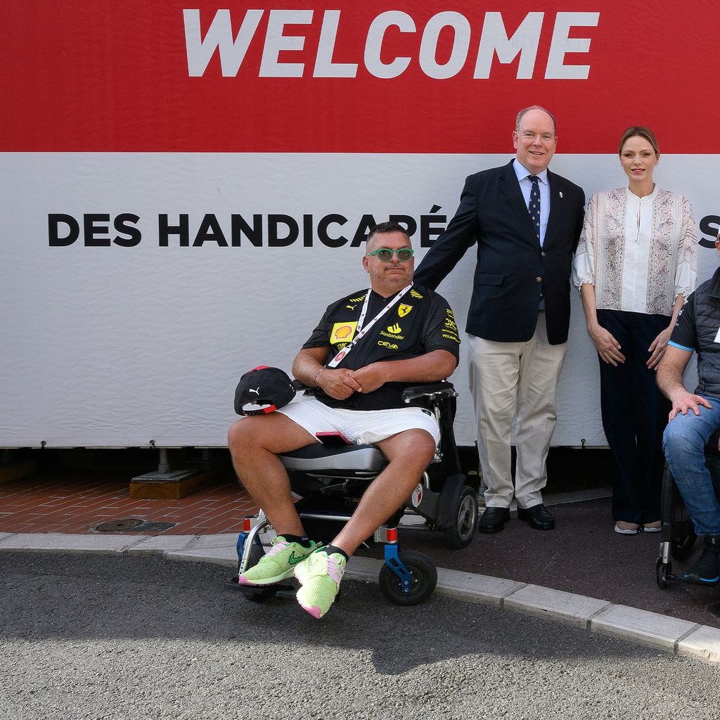Princess Charlene and Albert sit next to men