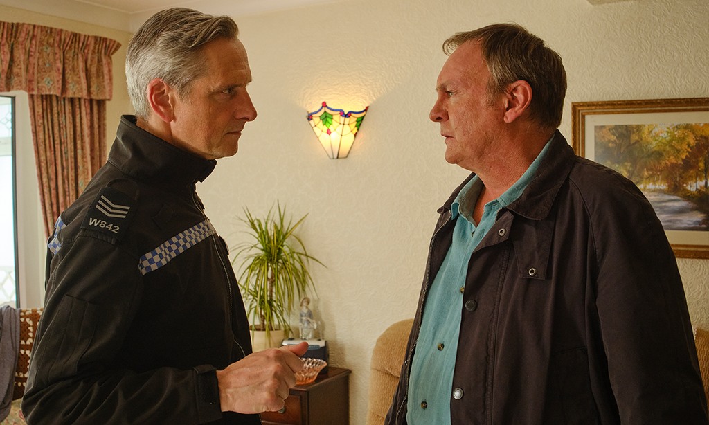 two men standing in living room
