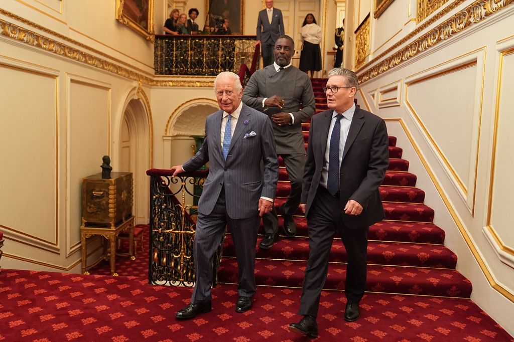 King Charles III walks with actor Idris Elba and Prime Minister Keir Starmer at a Youth Opportunity Summit at St James's Palace in London on July 15, 2025