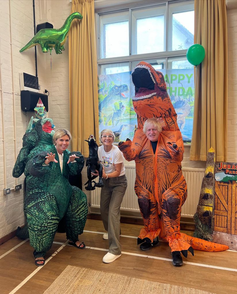 two people wearing dinosaur costumes