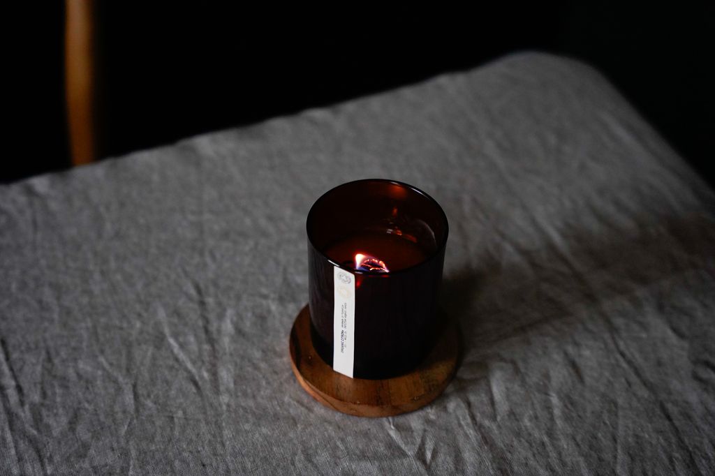 candles on a crinkled bed sheet