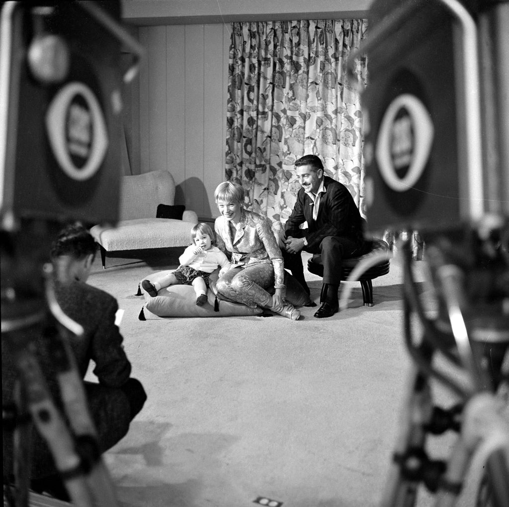 American actress and entertainer Shirley MacLaine poses with her husband, Steve Parker, and their daughter, Sachi Parker, in their home on an episode of the CBS celebrity interview program 'Person to Person,' March 6, 1959