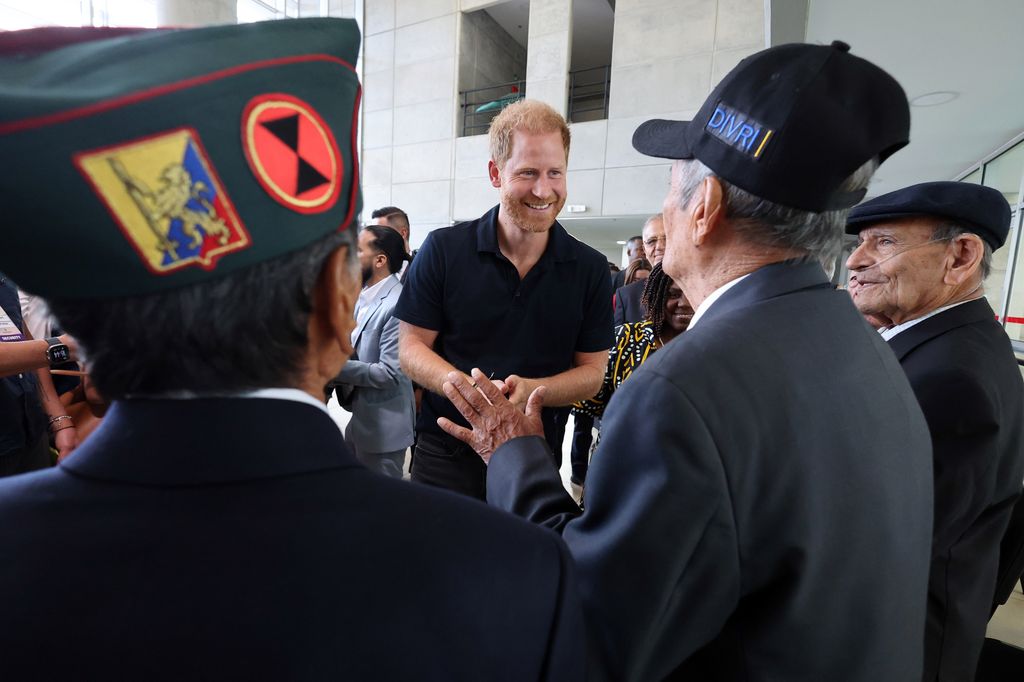 Prince Harry meeting several military veterans 