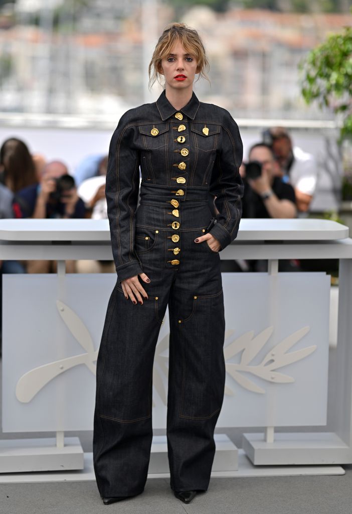 Maya Hawke looked cool in a dark denim jumpsuit with gold button adornments 