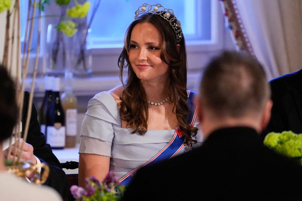 Princess Ingrid Alexandra smiles during King Harald's speech at state banquet