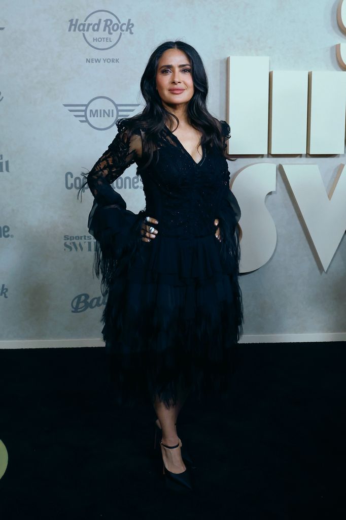 Salma posing in black lace dress