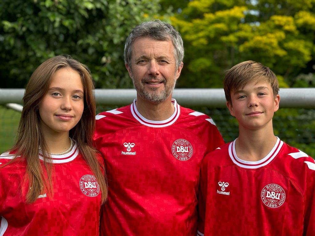 King Frederik with Princess Josephine and Prince Vincent in red Danish football tops