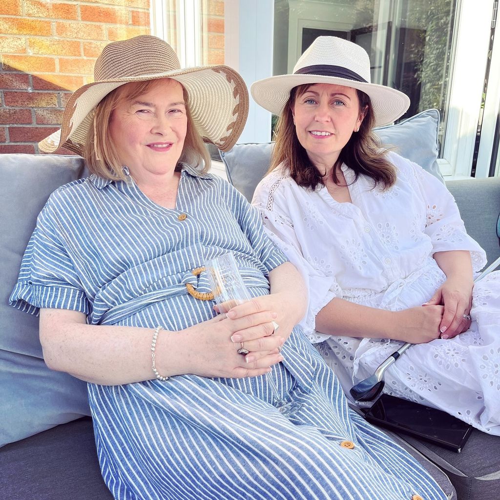 Susan Boyle wearing striped sundress and sunhat in 2025