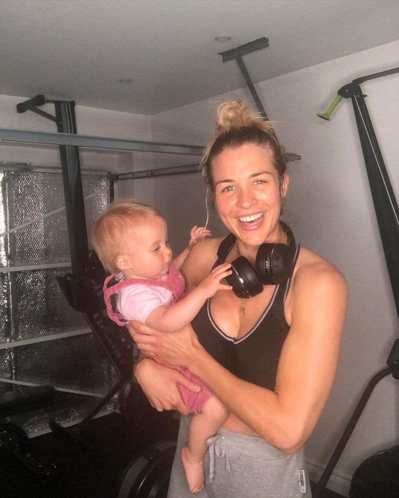Gemma Atkinson pictured in gymwear holding daughter Mia