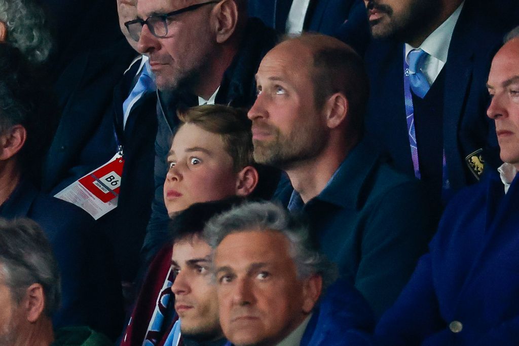 Prince George and Prince William looking serious at Villa match