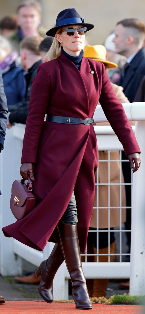 Zara in knee-high boots and burgundy coat