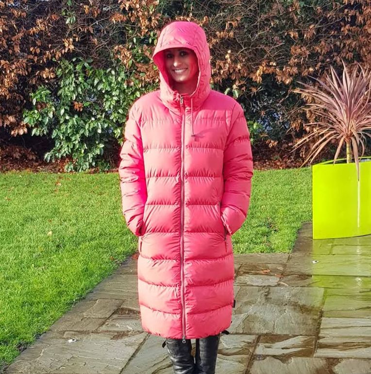 Naga Munchetty standing in her garden in a pink puffer coat