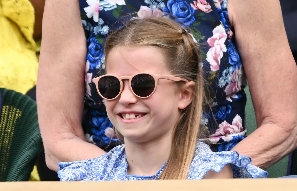 Princess Charlotte smiling in a pair of sunglasses