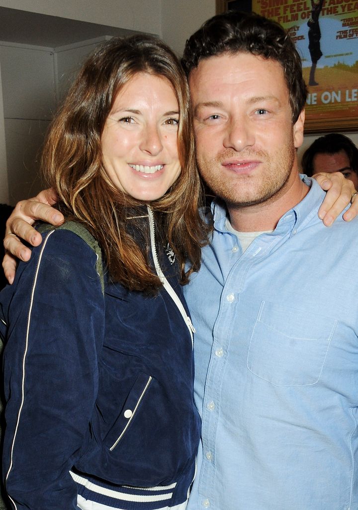 Jools Oliver standing with Jamie Oliver in blue outfits