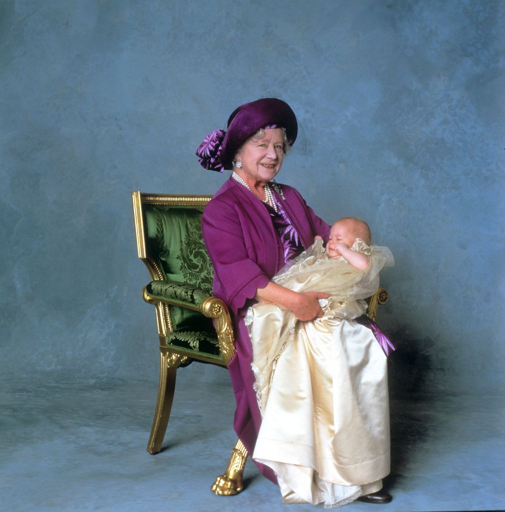 The Queen Mother holding Prince Harry on his Christening