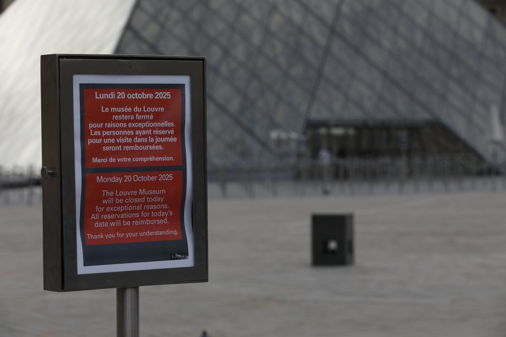 A general view shows the Louvre Museum a day after thieves stole eight priceless royal pieces of jewelry from the museum, as tourists continue to visit the area to take photos despite the closure, in Paris, France, on October 20, 2025